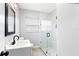 Modern bathroom with a glass-enclosed shower, neutral walls, updated vanity, and natural light from the window at 168 Boynton Blvd, Daytona Beach, FL 32118