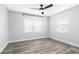 An empty bedroom with hardwood floors, fan and two windows at 168 Boynton Blvd, Daytona Beach, FL 32118