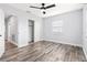 Cozy bedroom featuring wood-look floors, neutral walls, a modern ceiling fan, and ample closet space at 168 Boynton Blvd, Daytona Beach, FL 32118