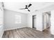 Bedroom with wood-look floors, fan, closet and two windows at 168 Boynton Blvd, Daytona Beach, FL 32118