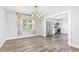 Bright dining area with wood floors, chandelier, and stainless steel refrigerator visible at 168 Boynton Blvd, Daytona Beach, FL 32118