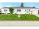 Charming single-story home with a well-manicured lawn, tidy landscaping and a driveway to the side at 168 Boynton Blvd, Daytona Beach, FL 32118