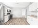 Bright kitchen showcasing updated appliances, white cabinets, and new flooring at 168 Boynton Blvd, Daytona Beach, FL 32118