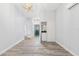 Inviting living room featuring modern lighting, clean white walls, and wood floors, with easy access to laundry area at 168 Boynton Blvd, Daytona Beach, FL 32118
