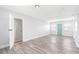 Open living space with wood-look floors, neutral walls, and plenty of natural light through windows and open door at 168 Boynton Blvd, Daytona Beach, FL 32118