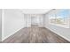 Bright living room features wood floors, white walls, and large windows providing ample natural light at 168 Boynton Blvd, Daytona Beach, FL 32118