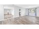 Spacious living area featuring wood-look floors, neutral walls, and an open doorway leading to other rooms at 168 Boynton Blvd, Daytona Beach, FL 32118