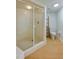 Clean bathroom showcasing a glass-enclosed shower, toilet, and wooden shelf at 4545 S Atlantic Ave # 3206, Port Orange, FL 32127