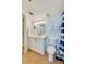 Neat bathroom featuring a modern vanity, toilet, and a blue-striped shower curtain at 4545 S Atlantic Ave # 3206, Port Orange, FL 32127