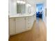 Bright bathroom featuring a double vanity with white cabinets and modern fixtures, leading to a bedroom at 4545 S Atlantic Ave # 3206, Port Orange, FL 32127