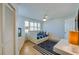 Bright bedroom featuring a trundle bed, ceiling fan, white closet, and large windows at 4545 S Atlantic Ave # 3206, Port Orange, FL 32127