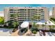 Beachside condo building featuring direct beach access, ample parking, and tropical landscaping at 4545 S Atlantic Ave # 3206, Port Orange, FL 32127