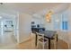 Bright dining area with hardwood floors, stylish lighting, and seating for four at 4545 S Atlantic Ave # 3206, Port Orange, FL 32127