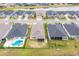 Aerial shot of lakefront homes with pools and patios, highlighting backyard amenities and neighborhood design at 604 Mosaic Blvd, Daytona Beach, FL 32124