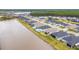 Community aerial view, backing onto a lake, showing neighborhood layout and many residences at 604 Mosaic Blvd, Daytona Beach, FL 32124
