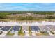 Aerial view showcasing waterfront homes with well-manicured lawns, reflecting a desirable community at 604 Mosaic Blvd, Daytona Beach, FL 32124