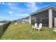 Beautiful backyard with screened lanai, overlooking a serene pond, ideal for outdoor living at 604 Mosaic Blvd, Daytona Beach, FL 32124