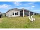 Well-maintained backyard with a screened lanai and lush lawn, offering privacy and outdoor enjoyment at 604 Mosaic Blvd, Daytona Beach, FL 32124