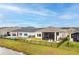 Aerial view of a fenced backyard featuring a screened patio and ample green space at 604 Mosaic Blvd, Daytona Beach, FL 32124