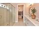 Stylish bathroom featuring a walk-in shower, double vanity, and a view into the closet at 604 Mosaic Blvd, Daytona Beach, FL 32124