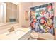 Playful bathroom with a tub-shower, bright character-themed curtain, and neutral walls at 604 Mosaic Blvd, Daytona Beach, FL 32124