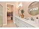 Modern bathroom with double vanities, walk-in shower, and convenient access to a spacious closet at 604 Mosaic Blvd, Daytona Beach, FL 32124
