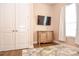 Neutral bedroom featuring a television, closet, and a soft patterned rug at 604 Mosaic Blvd, Daytona Beach, FL 32124