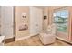 Cozy Bedroom with a comfortable chair, a window view and white trim at 604 Mosaic Blvd, Daytona Beach, FL 32124
