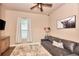 Relaxing bedroom with a soft leather sofa, a ceiling fan and neutral toned walls at 604 Mosaic Blvd, Daytona Beach, FL 32124