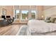 Bright bedroom featuring three large windows overlooking a serene lake and a modern office setup at 604 Mosaic Blvd, Daytona Beach, FL 32124