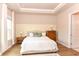 Charming bedroom showcasing a comfortable bed, decorative wall panels, and ensuite bathroom access at 604 Mosaic Blvd, Daytona Beach, FL 32124