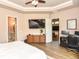 Bright bedroom featuring access to ensuite bathroom, media cabinet, and views of the backyard at 604 Mosaic Blvd, Daytona Beach, FL 32124