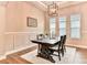 Well-lit dining room featuring a wooden table, decorative rug, and modern light fixture at 604 Mosaic Blvd, Daytona Beach, FL 32124