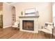Close-up of an elegant brick fireplace with white accents, flanked by comfortable seating at 604 Mosaic Blvd, Daytona Beach, FL 32124