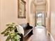 Elegant foyer featuring hardwood floors, a cozy bench, decorative mirror, and a bright, inviting entrance at 604 Mosaic Blvd, Daytona Beach, FL 32124