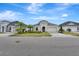 Street view of three elegant homes with well-kept lawns, stone driveways, and meticulously manicured greenery at 604 Mosaic Blvd, Daytona Beach, FL 32124