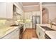Gourmet kitchen with stainless appliances, marble counters, custom cabinets, and an open-concept layout at 604 Mosaic Blvd, Daytona Beach, FL 32124
