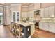 Bright kitchen featuring a large island with seating, stainless appliances, white cabinetry, and modern lighting at 604 Mosaic Blvd, Daytona Beach, FL 32124