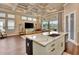 Open-concept kitchen featuring a large island with stone countertop and stainless steel appliances, perfect for entertaining at 604 Mosaic Blvd, Daytona Beach, FL 32124