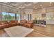 Spacious living room featuring coffered ceilings, wood floors, large windows, and seamless kitchen access at 604 Mosaic Blvd, Daytona Beach, FL 32124