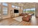 Bright and spacious living room featuring a coffered ceiling, a large sofa, and floor-to-ceiling windows with outdoor views at 604 Mosaic Blvd, Daytona Beach, FL 32124