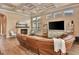 Living room with a brick fireplace, large windows for natural light, coffered ceilings, and comfortable seating at 604 Mosaic Blvd, Daytona Beach, FL 32124