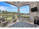 Inviting screened patio with lounge seating, ceiling fan, and a serene view of the pool and pond at 604 Mosaic Blvd, Daytona Beach, FL 32124