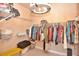 Bright walk-in closet with extensive shelving, clothing racks and a decorative chandelier at 604 Mosaic Blvd, Daytona Beach, FL 32124