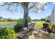 Scenic backyard featuring a tranquil lake view with green spaces and shade at 6123 Jasmine Vine Dr, Port Orange, FL 32128