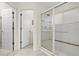 Bathroom showcasing a glass-enclosed shower with neutral tile at 6123 Jasmine Vine Dr, Port Orange, FL 32128
