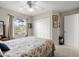 Comfortable bedroom with a ceiling fan, closet, and window overlooking the outside at 6123 Jasmine Vine Dr, Port Orange, FL 32128