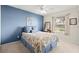 Comfortable bedroom with floral bedding, a window view, and calming blue wall at 6123 Jasmine Vine Dr, Port Orange, FL 32128