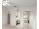 Bedroom featuring ensuite bath access and mirrored closet doors at 6123 Jasmine Vine Dr, Port Orange, FL 32128