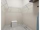 Walk-in closet with ample shelving, clothing rack and seating at 6123 Jasmine Vine Dr, Port Orange, FL 32128
